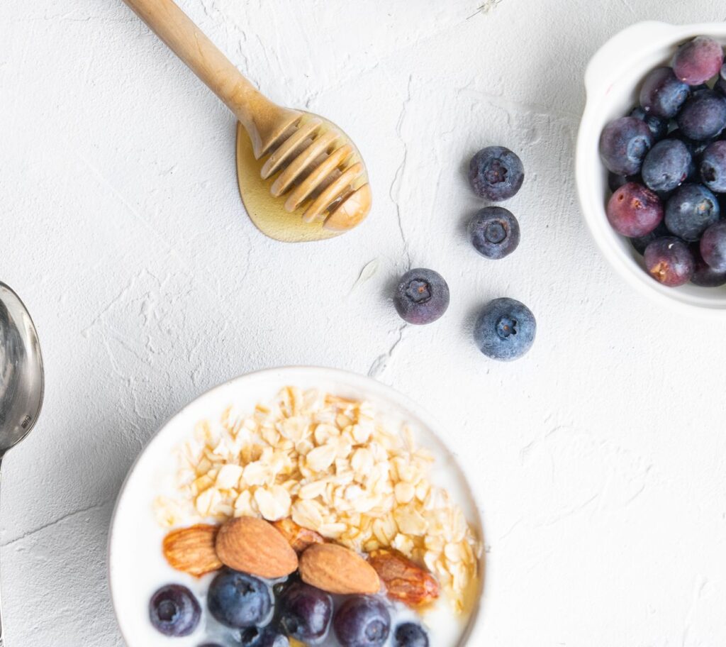 Table showing a bowl with yogurt, oats, and blueberries.
